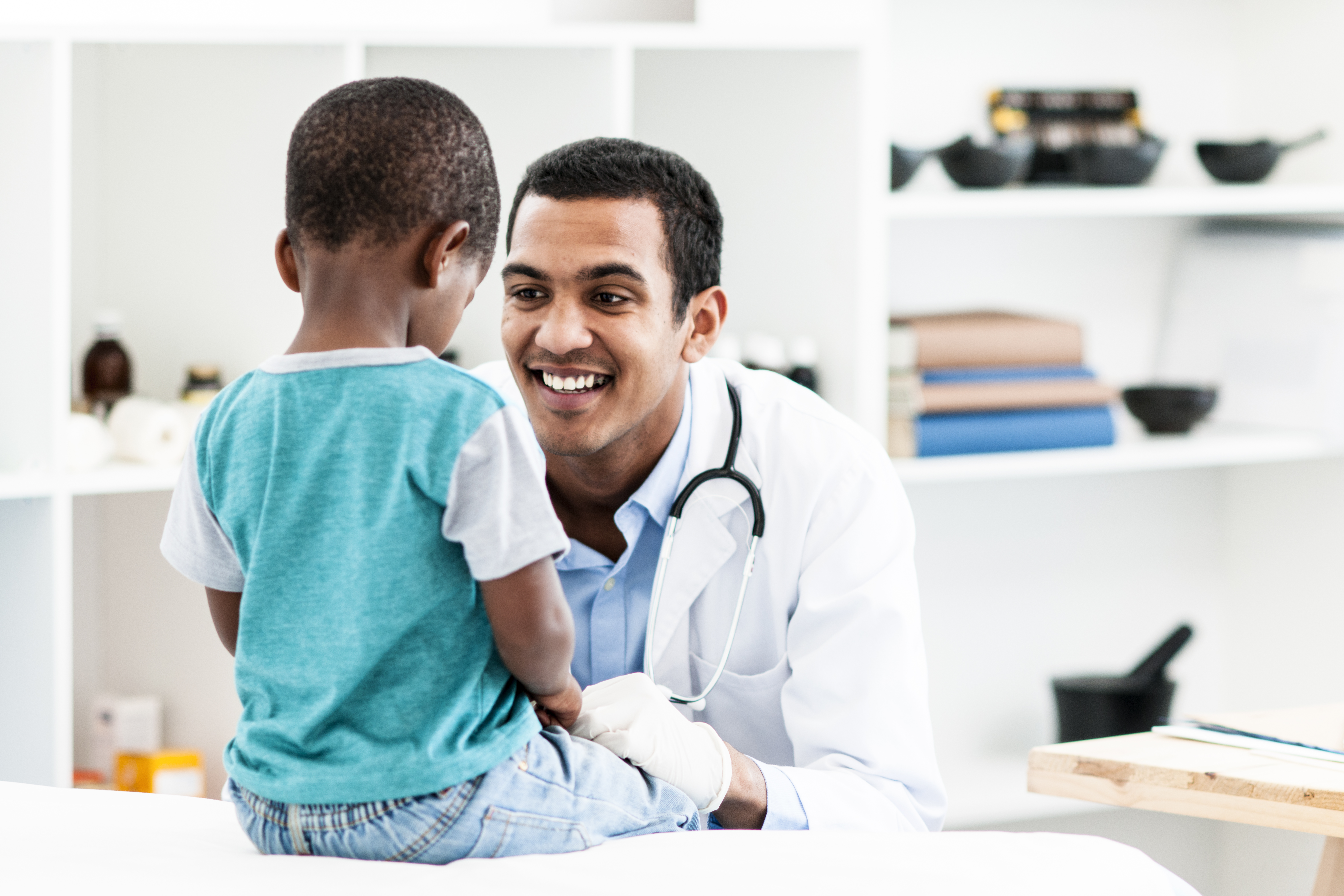 Doctor examining little boy